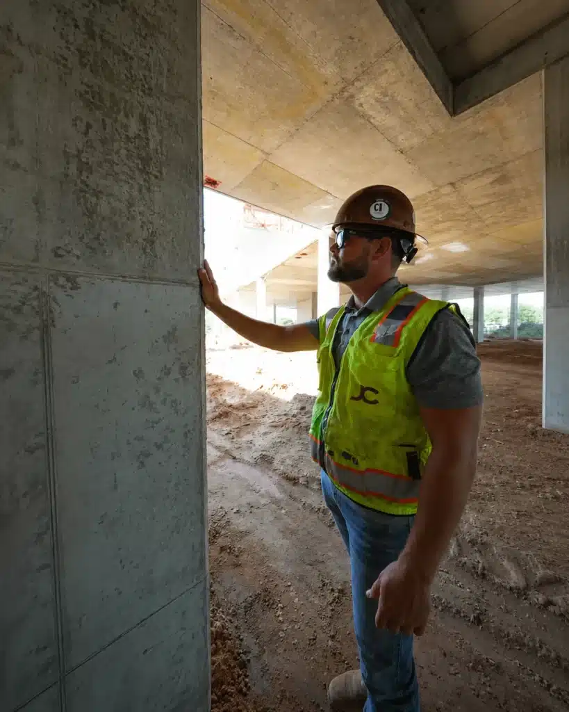Worker inspecting a concrete column at Perla Student Housing in Tallahassee FL